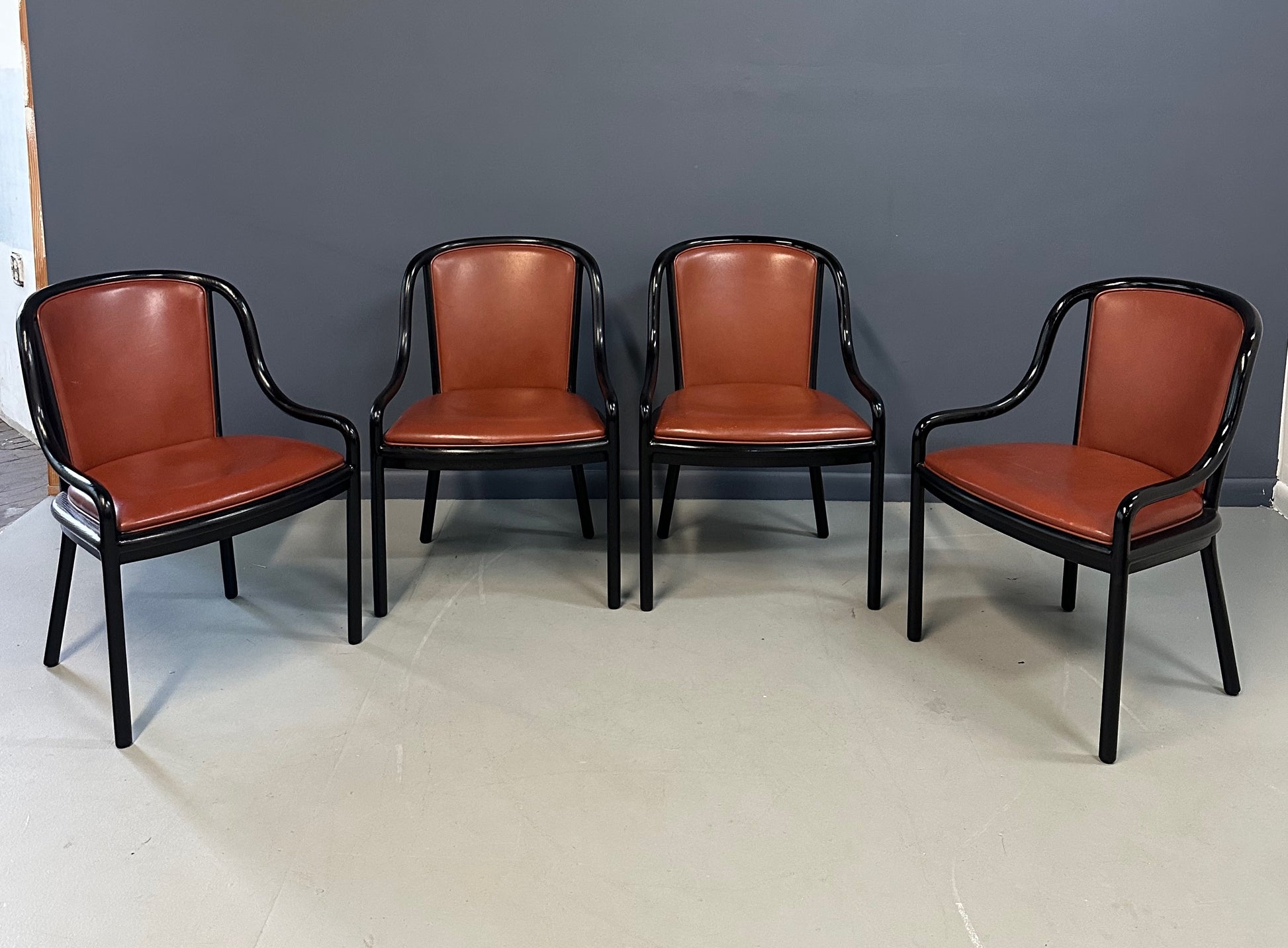 Set of four rare 1970s Ward Bennett Landmark Variation chairs for Brickel Associates, featuring black lacquered frames and rust leather upholstery—mid-century modern design