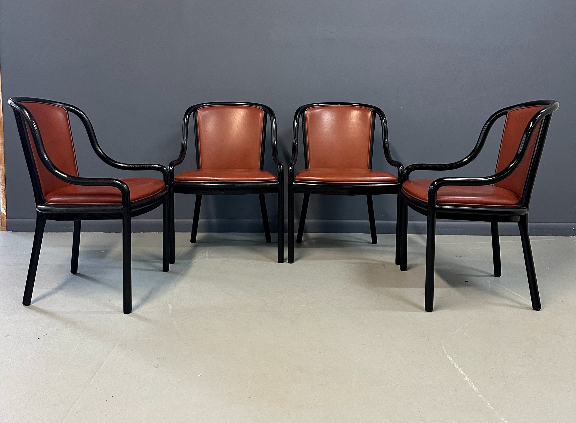 Set of four rare 1970s Ward Bennett Landmark Variation chairs for Brickel Associates, featuring black lacquered frames and rust leather upholstery—mid-century modern design