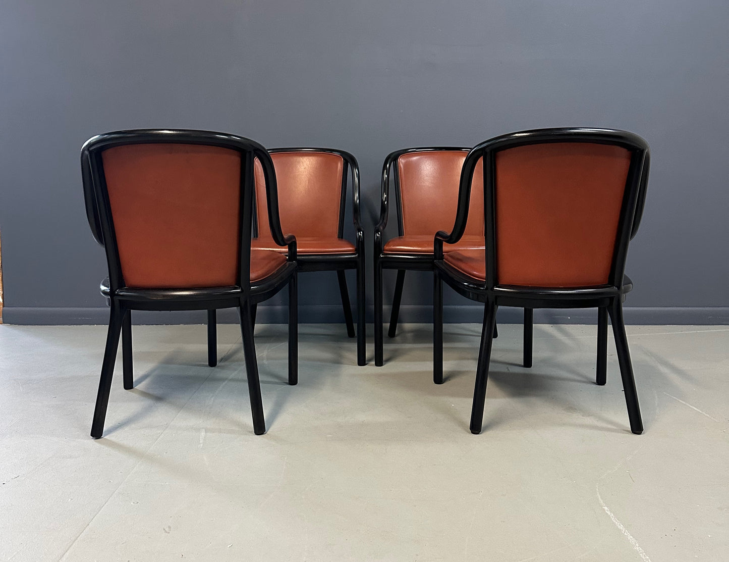 Set of four rare 1970s Ward Bennett Landmark Variation chairs for Brickel Associates, featuring black lacquered frames and rust leather upholstery—mid-century modern design