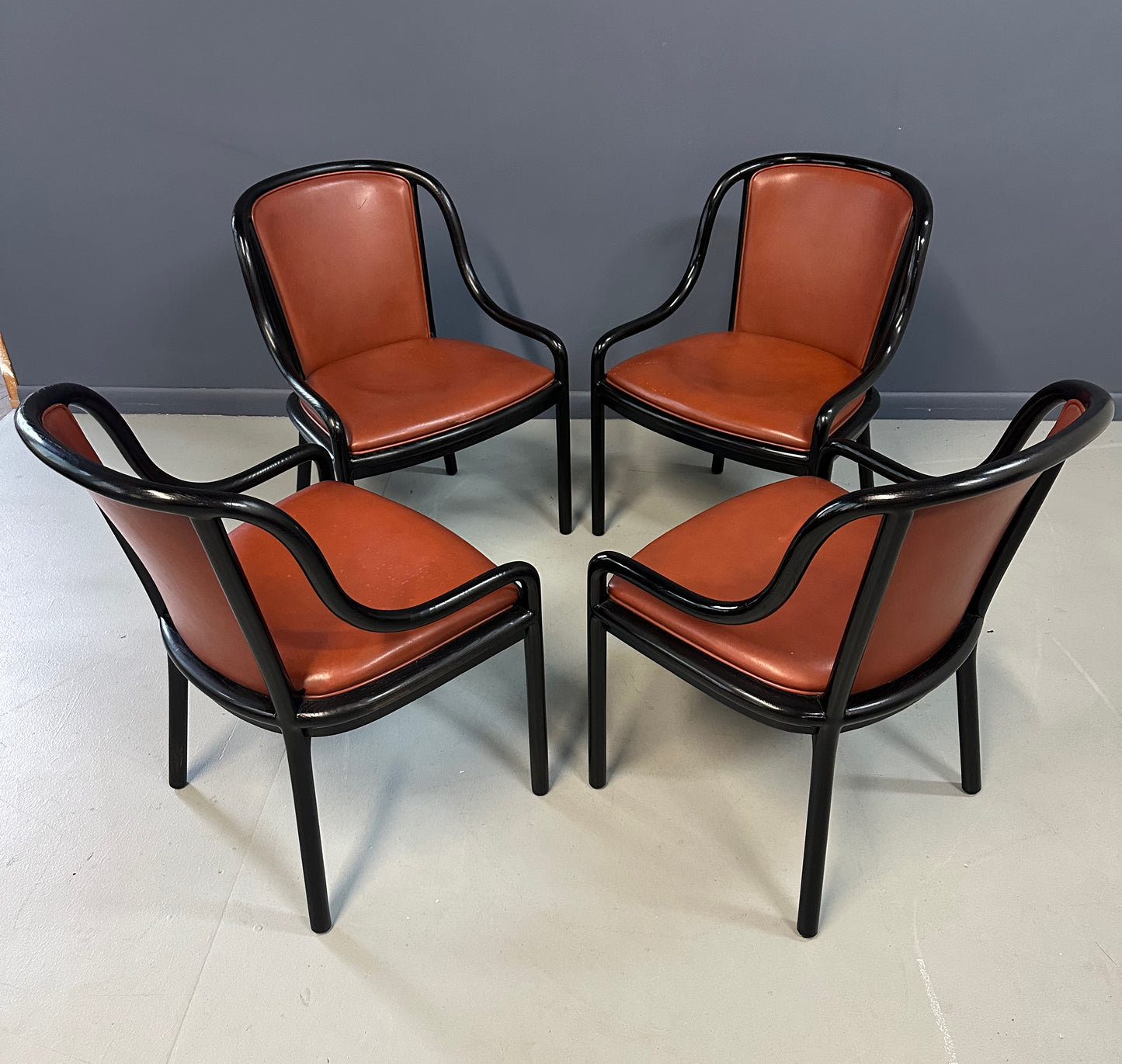 Set of four rare 1970s Ward Bennett Landmark Variation chairs for Brickel Associates, featuring black lacquered frames and rust leather upholstery—mid-century modern design