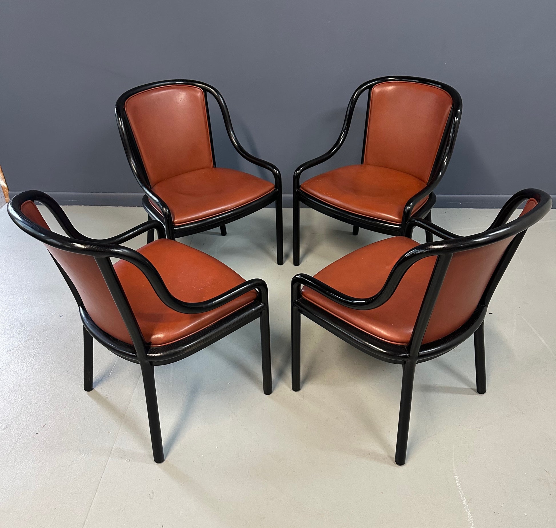 Set of four rare 1970s Ward Bennett Landmark Variation chairs for Brickel Associates, featuring black lacquered frames and rust leather upholstery—mid-century modern design