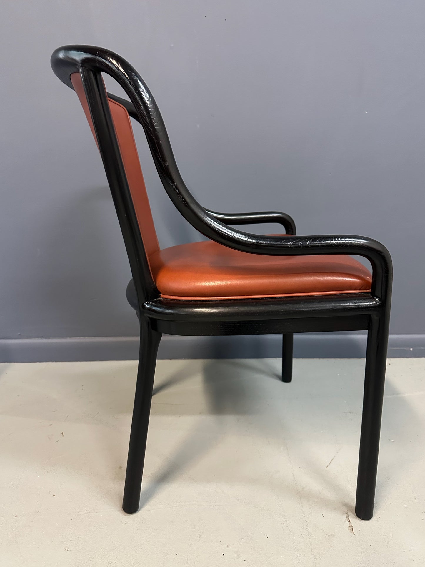 Set of four rare 1970s Ward Bennett Landmark Variation chairs for Brickel Associates, featuring black lacquered frames and rust leather upholstery—mid-century modern design
