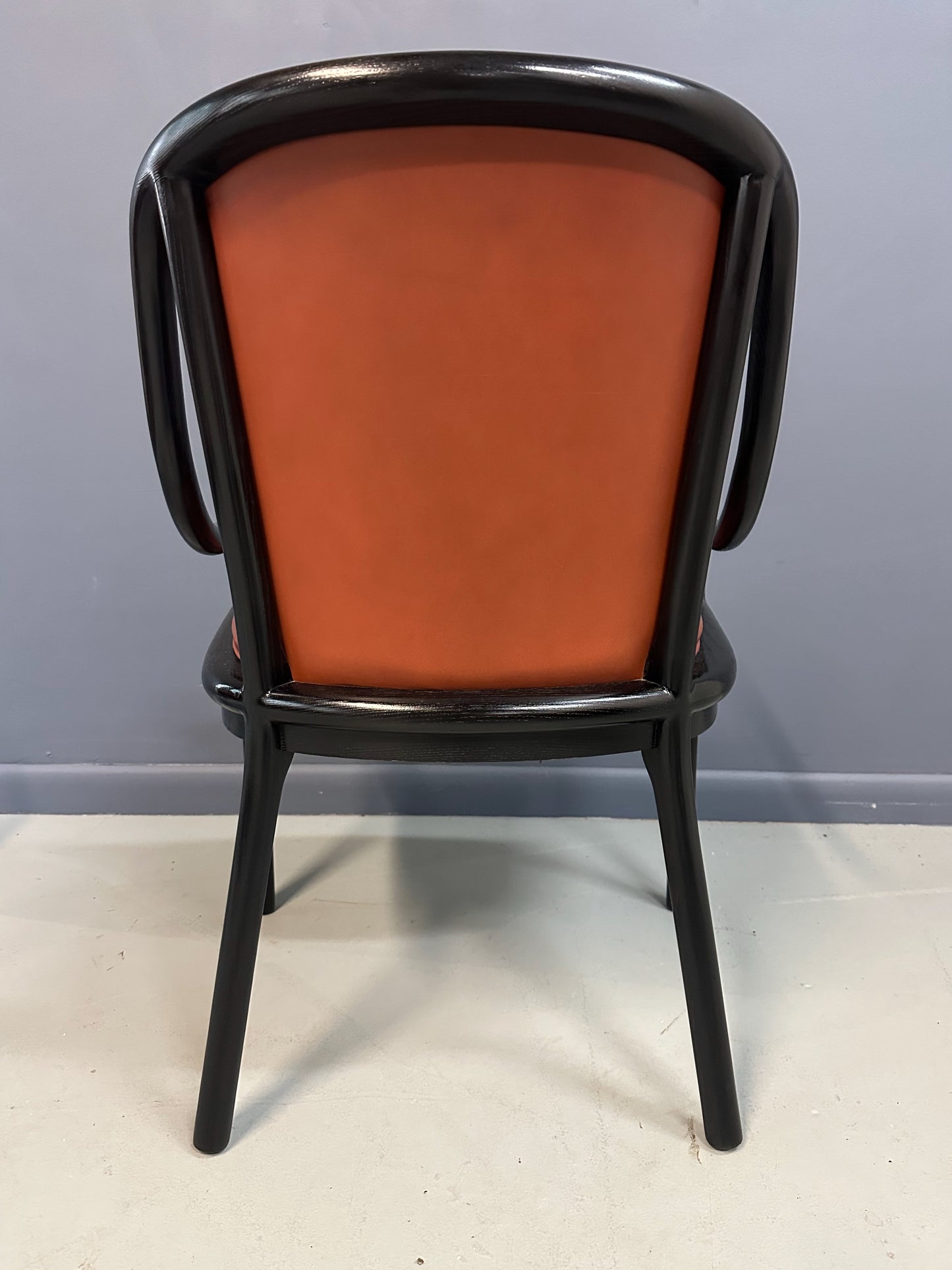Set of four rare 1970s Ward Bennett Landmark Variation chairs for Brickel Associates, featuring black lacquered frames and rust leather upholstery—mid-century modern design