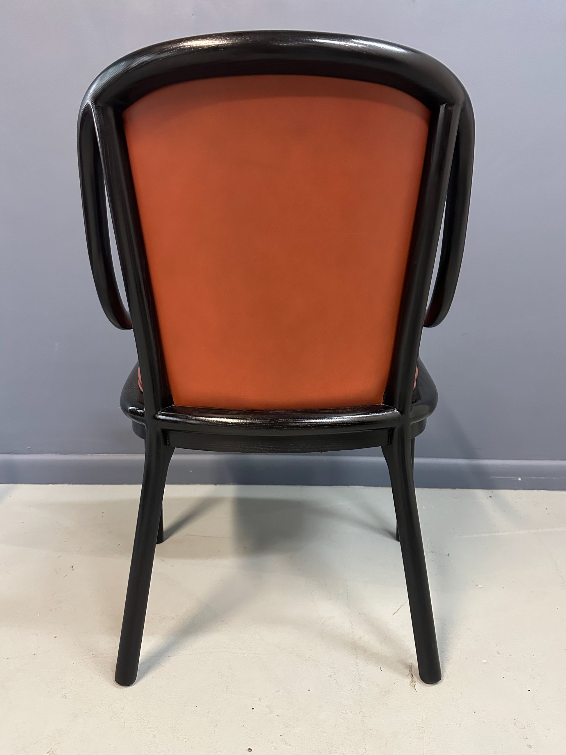 Set of four rare 1970s Ward Bennett Landmark Variation chairs for Brickel Associates, featuring black lacquered frames and rust leather upholstery—mid-century modern design