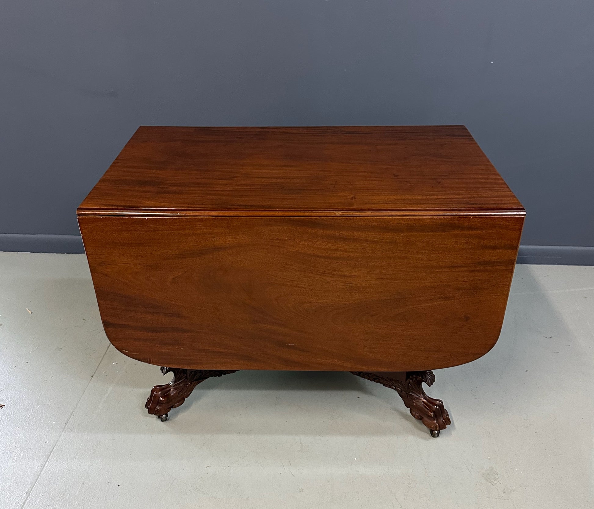 Circa 1845 Anthony Querville drop-leaf table in rich mahogany with carved pedestal base, acanthus detailing, and claw feet—classic American Empire antique furniture