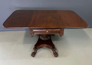 Circa 1845 Anthony Querville drop-leaf table in rich mahogany with carved pedestal base, acanthus detailing, and claw feet—classic American Empire antique furniture
