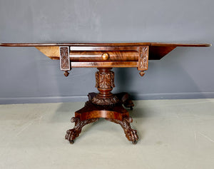 Circa 1845 Anthony Querville drop-leaf table in rich mahogany with carved pedestal base, acanthus detailing, and claw feet—classic American Empire antique furniture