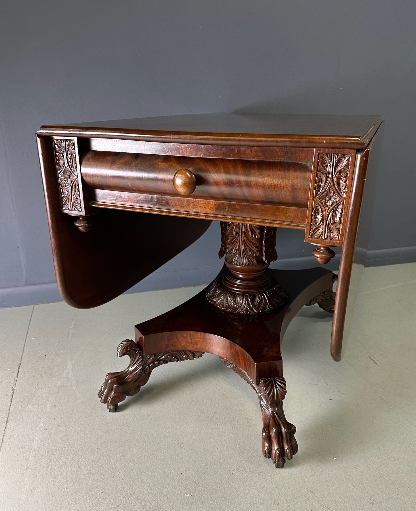 Circa 1845 Anthony Querville drop-leaf table in rich mahogany with carved pedestal base, acanthus detailing, and claw feet—classic American Empire antique furniture