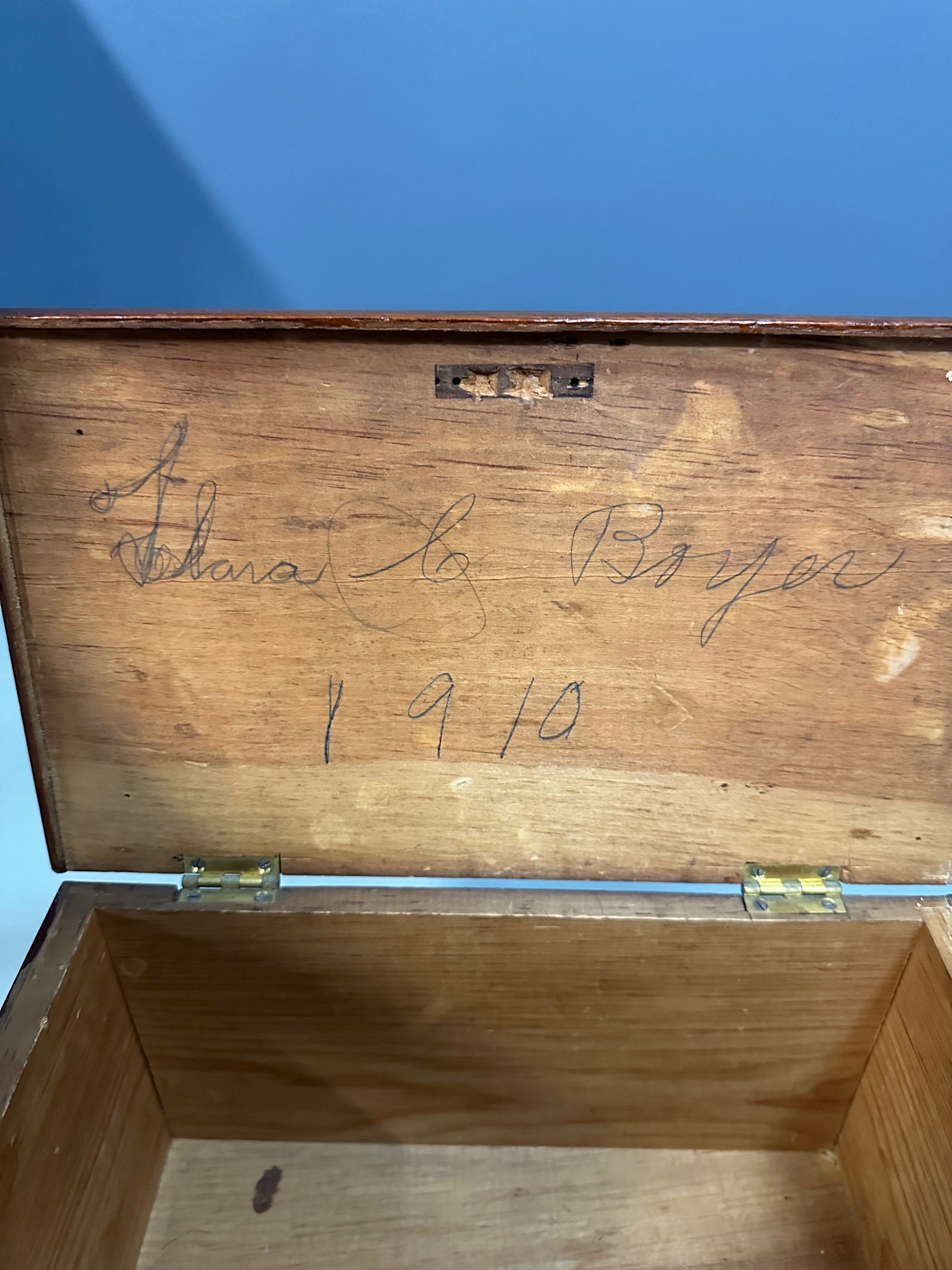 Miniature marquetry blanket chest dated 1910, handcrafted by Flora Boyer of Pennsylvania, featuring intricate geometric inlay patterns in warm-toned wood and a brass keyhole on the front