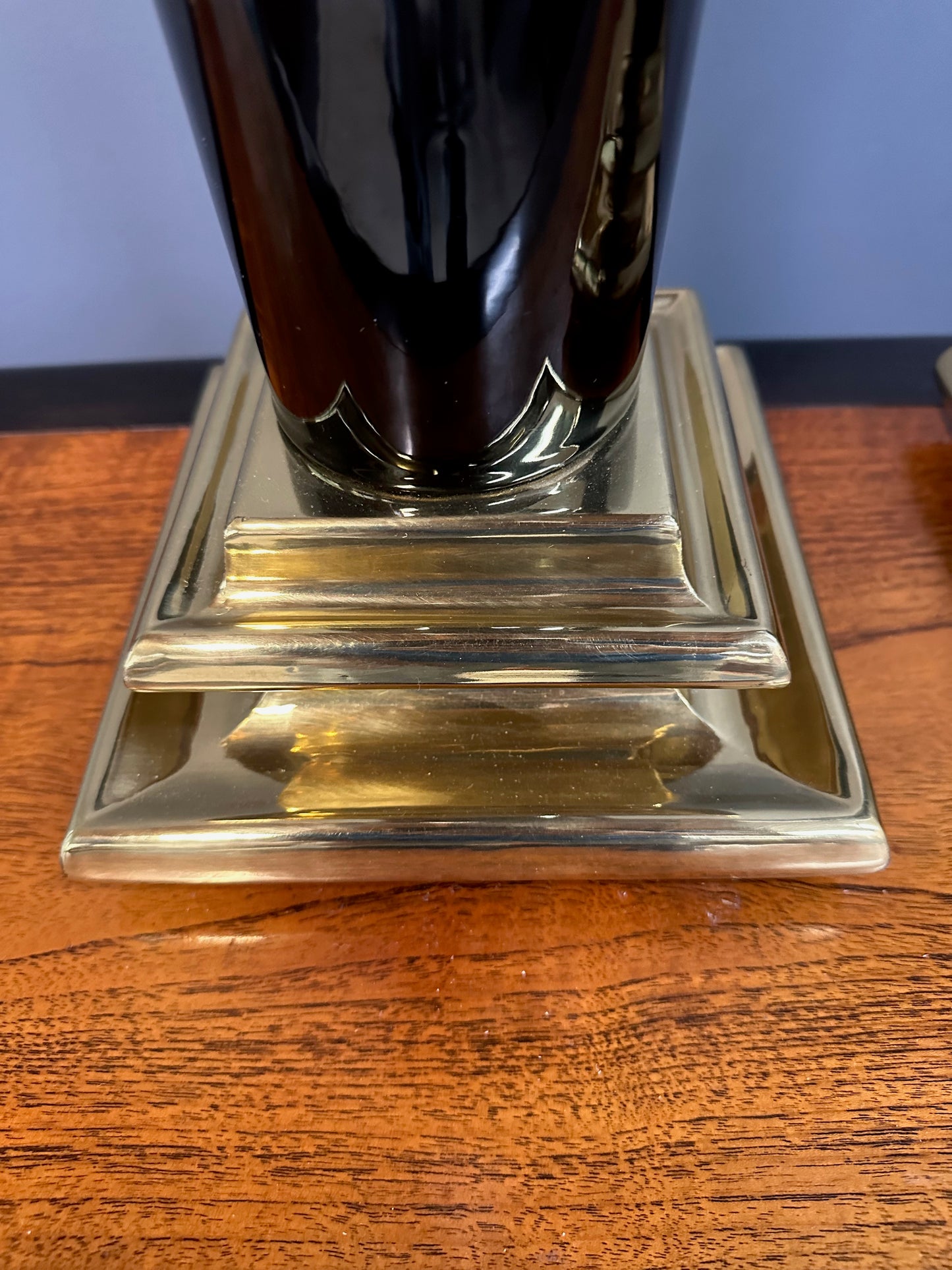 Pair of Hollywood Regency Black Ceramic Urn Lamps with Stepped Brass Bases by Chapman