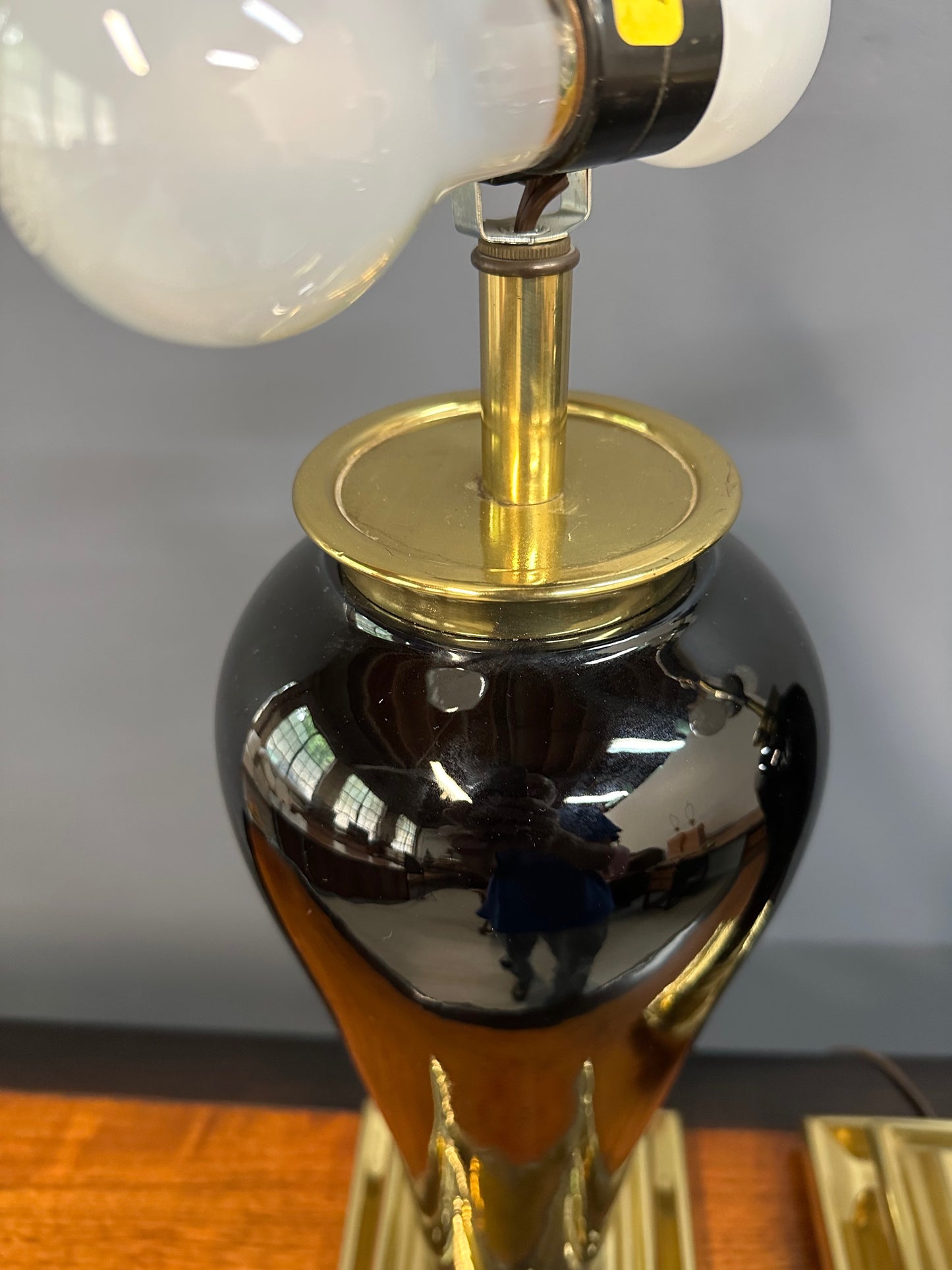 Pair of Hollywood Regency Black Ceramic Urn Lamps with Stepped Brass Bases by Chapman