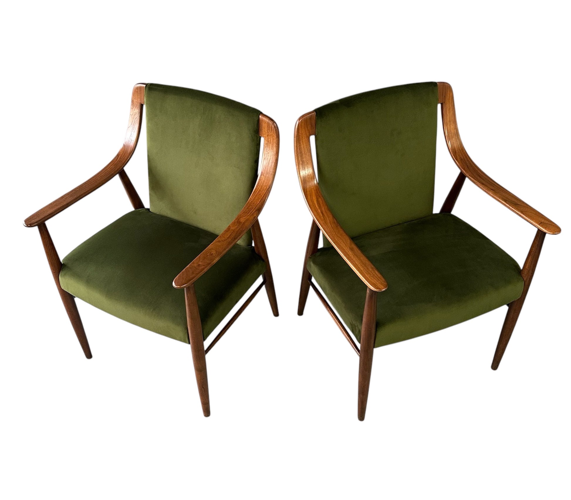 Pair of Danish lounge chairs in the style of Peter Hvidt, featuring sculptural walnut frames and green velvet upholstered seats and backs