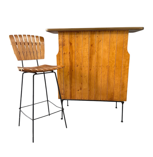 Mid-Century Modern dry bar console with matching stool by Arthur Umanoff, 1950s, featuring slatted wood panels, iron legs, and a curved wooden seat and backrest with minimalist black metal framing