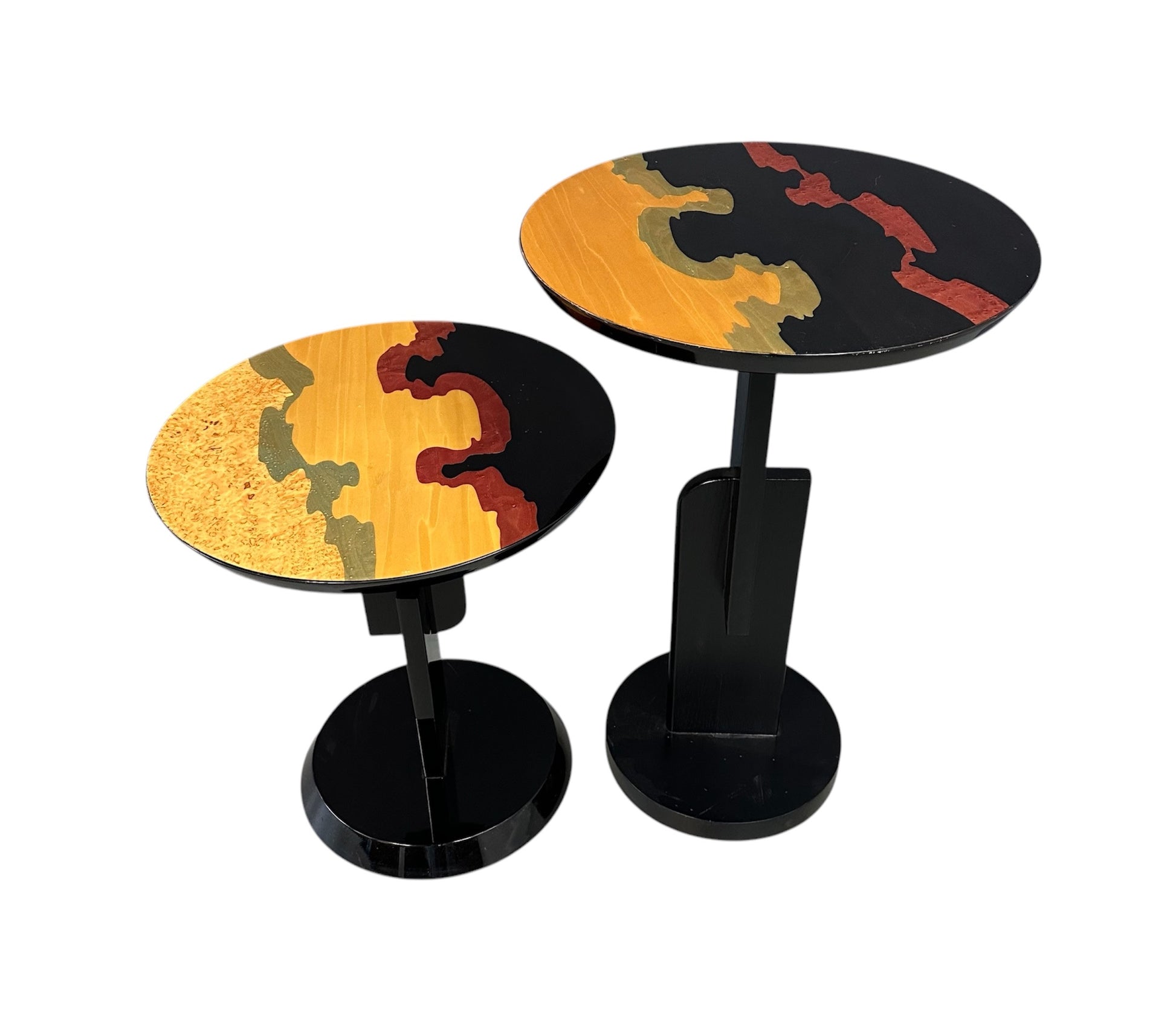Pair of Carlo Malnati style Postmodern side tables featuring round inlaid wood tops with abstract, multicolored organic patterns and sleek black pedestal bases.