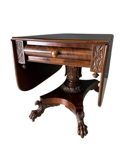 Circa 1845 Anthony Querville drop-leaf table in rich mahogany with carved pedestal base, acanthus detailing, and claw feet—classic American Empire antique furniture